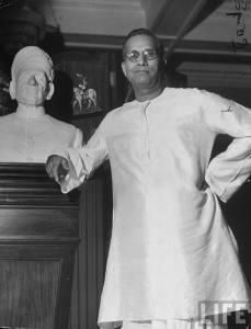 Indian Industrialist G. D. Birla (L) backer &amp; benefactor to Hindu ldr. Mohandas Gandhi, posing next to bust of his father, the founder of the Birla firm, at his palacial home 1946